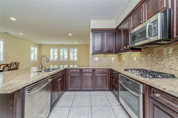 a kitchen with stainless steel appliances granite countertop a sink and stove