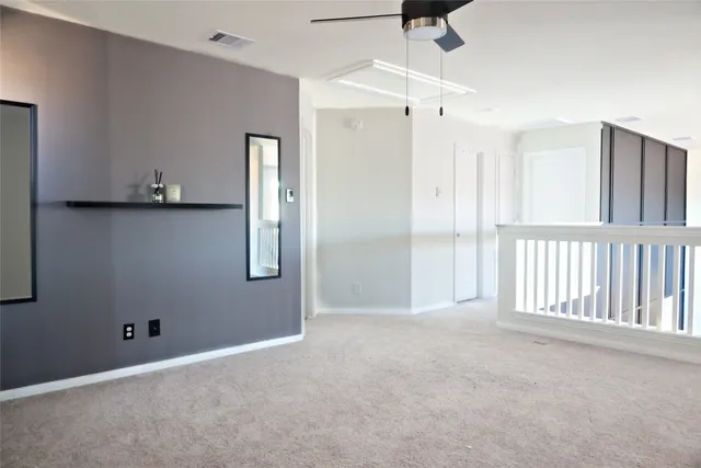 a view of an empty room with a cabinet