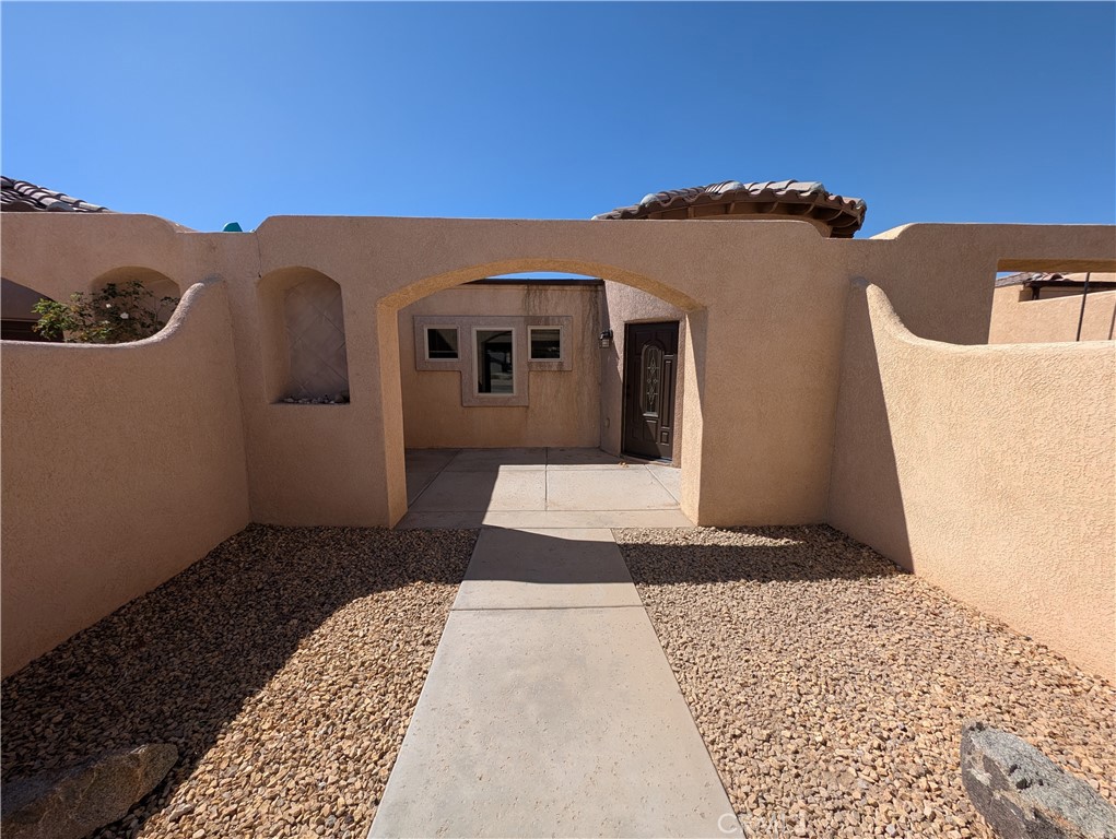 27160 Vista Road, Unit 21 Helendale, CA 92342 - Photo 2 of 11 a front view of a house with a yard