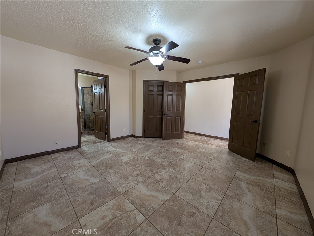 27160 Vista Road, Unit 21 Helendale, CA 92342 - Photo 5 of 11 a view of an empty room with a ceiling fan