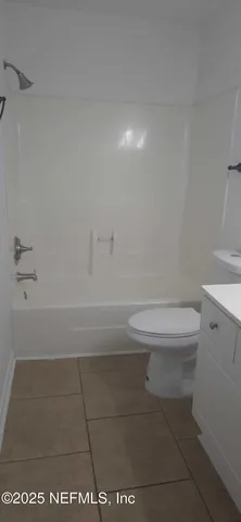 a bathroom with a sink vanity and a mirror