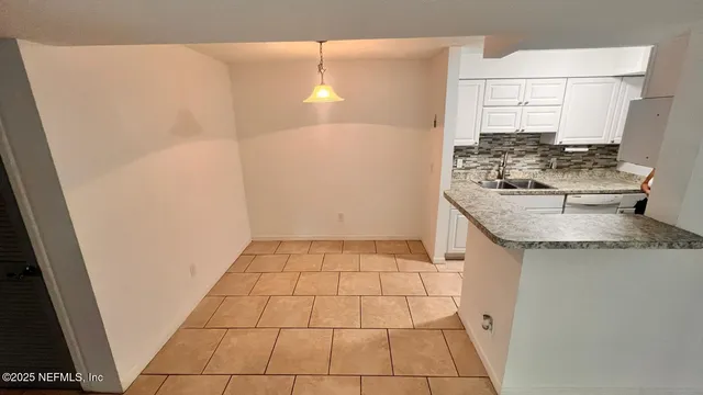 a kitchen with a sink a stove and cabinets