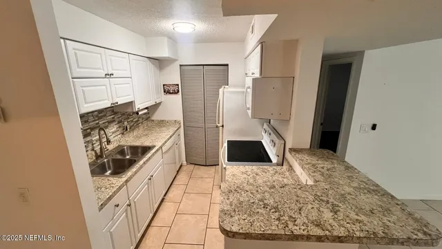 a view of a bathroom with bathtub and shower