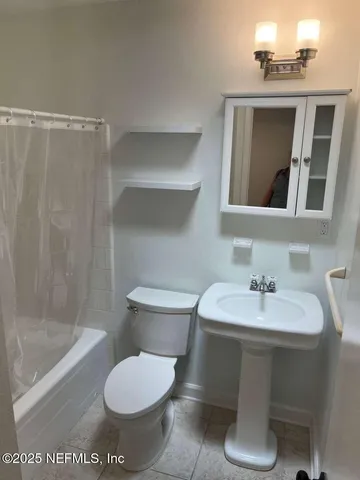 a white toilet sitting next to a bathroom sink