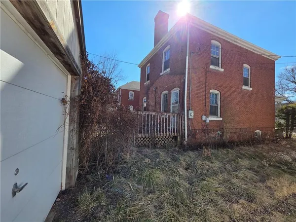 a view of a brick building next to a yard