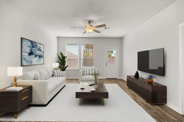 a living room with furniture and a flat screen tv