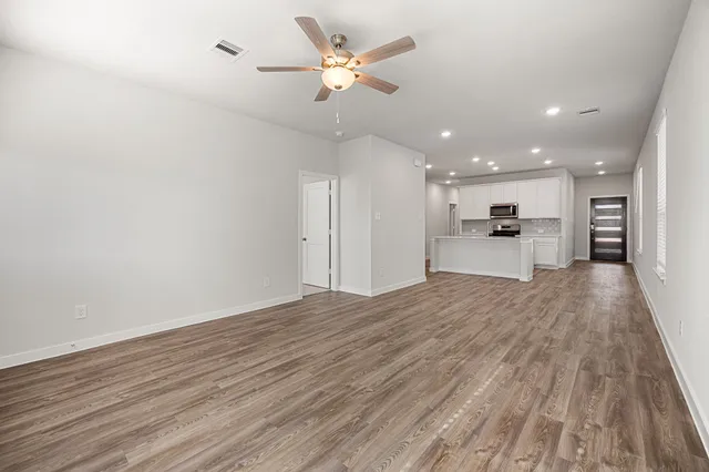 a view of a kitchen with a sink and a refrigerator