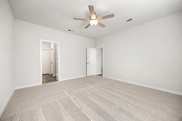 a view of a room with a ceiling fan