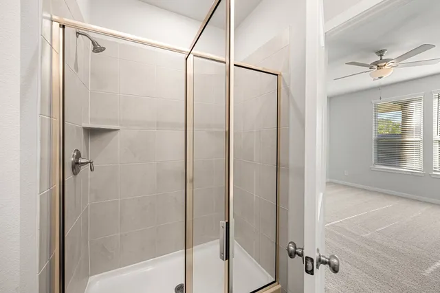 a bathroom with a glass shower door