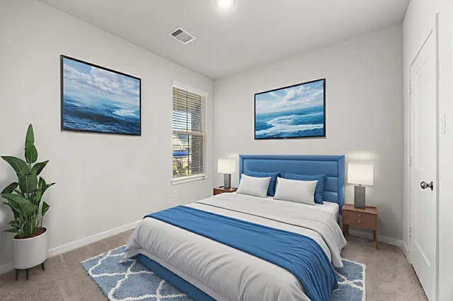 a bedroom with bed and a potted plant