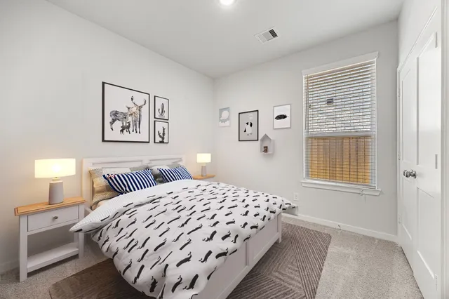 a bedroom with a bed and a night stand