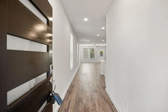 a view of hallway with wooden floor