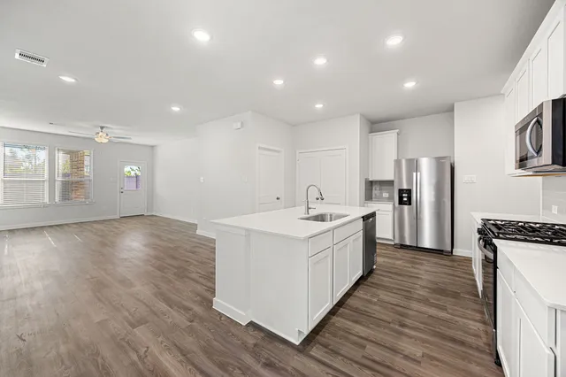a large kitchen with stainless steel appliances granite countertop a large center island and a sink