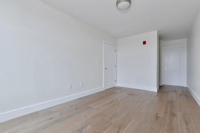 a view of an empty room and wooden floor