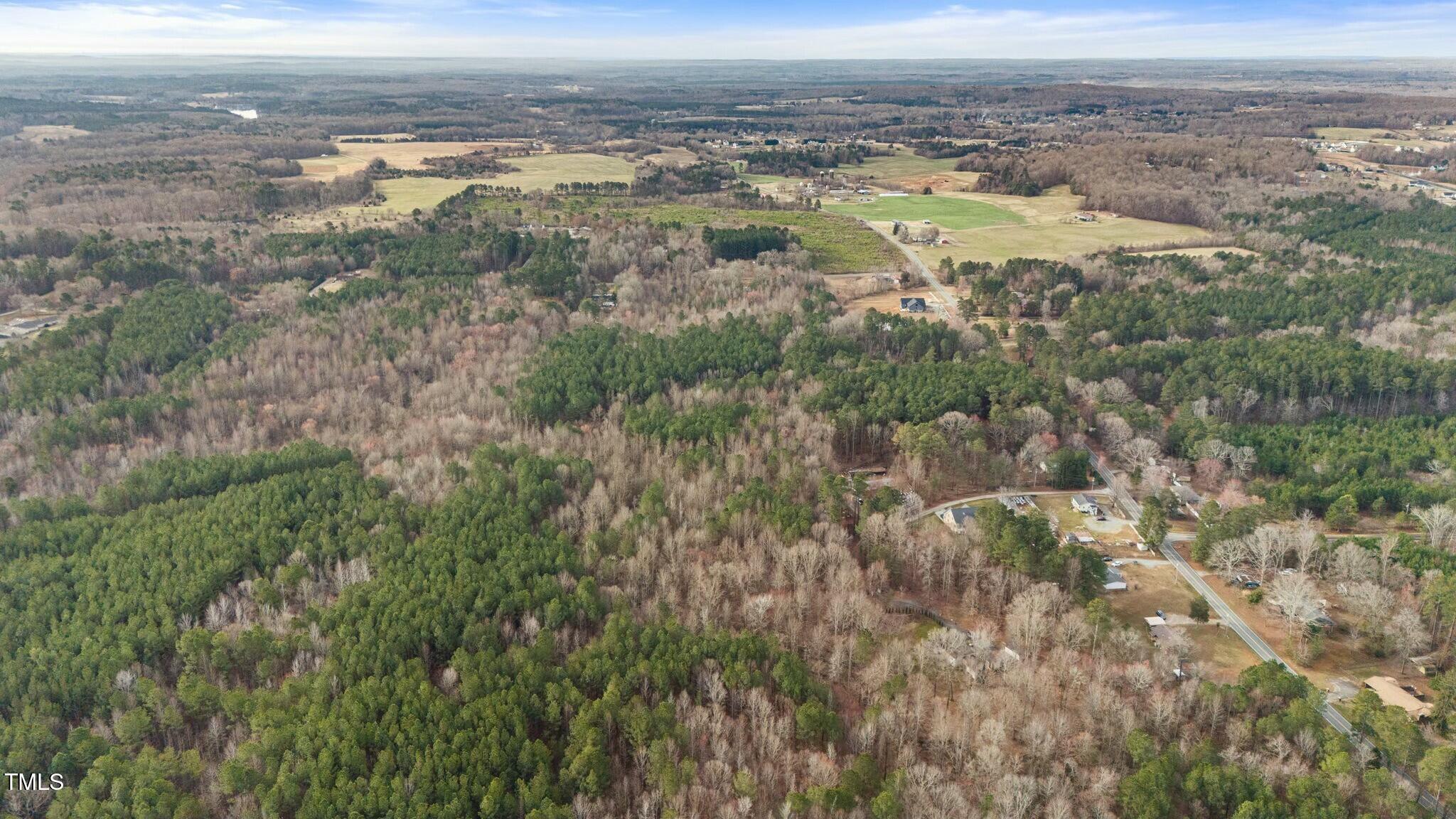 6621 Nicks Road Mebane, NC 27302 - Photo 5 of 10 an aerial view of mountains with green space and fog