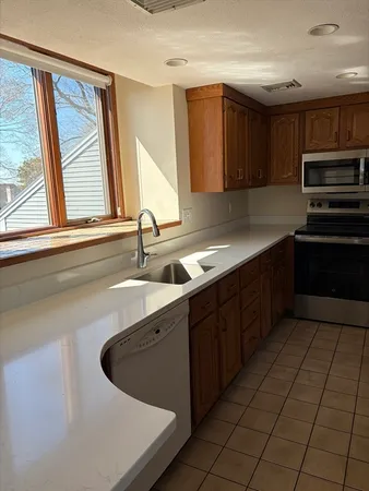a kitchen with stainless steel appliances a sink stove and cabinets