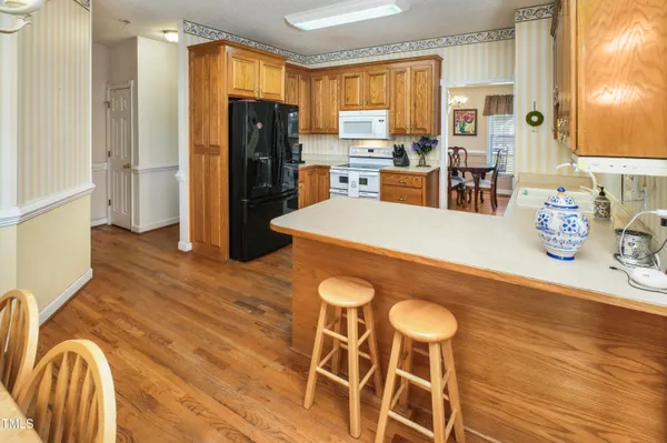 a kitchen with granite countertop cabinets and refrigerator