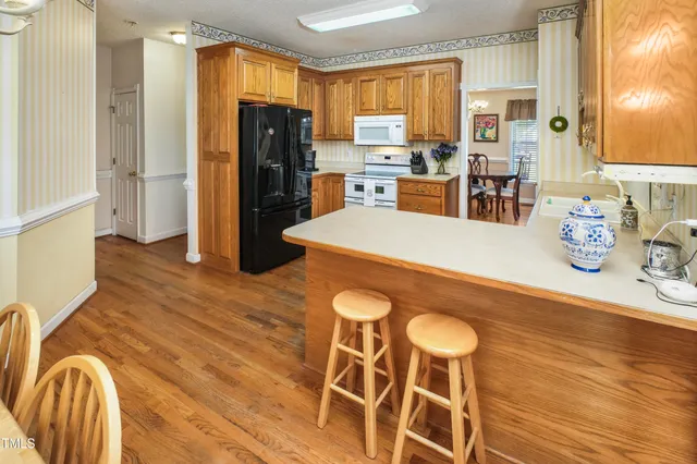 a kitchen with granite countertop cabinets and refrigerator