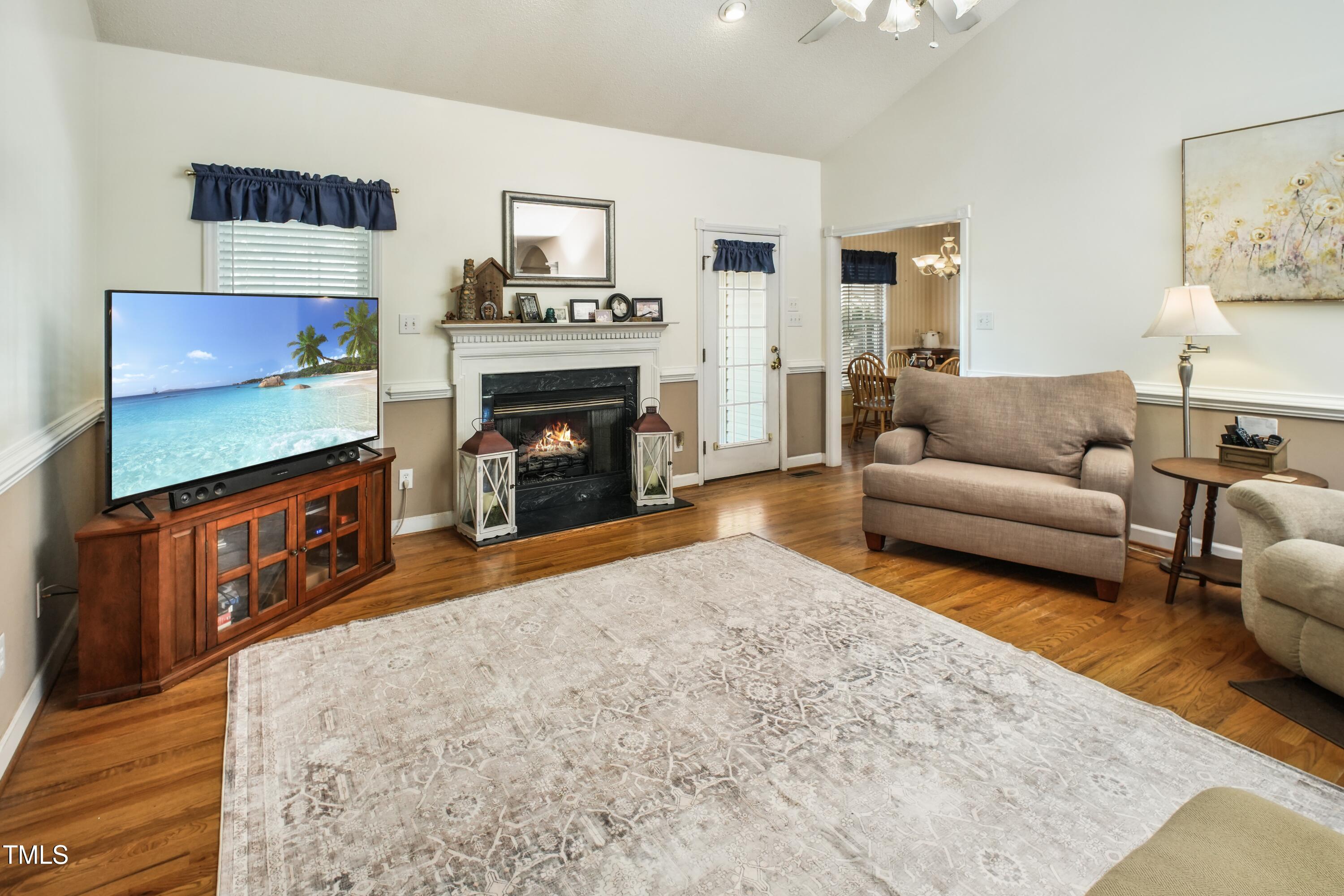 115 Hunters Walk Lane Clinton, NC 28328 - Photo 18 of 39 a living room with furniture a flat screen tv and a fireplace