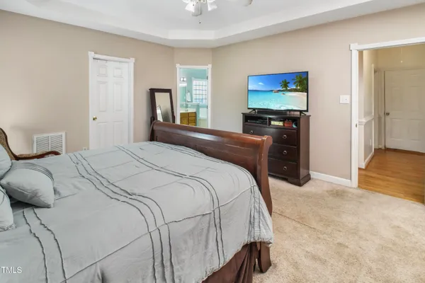 a bedroom with a bed and a flat screen tv