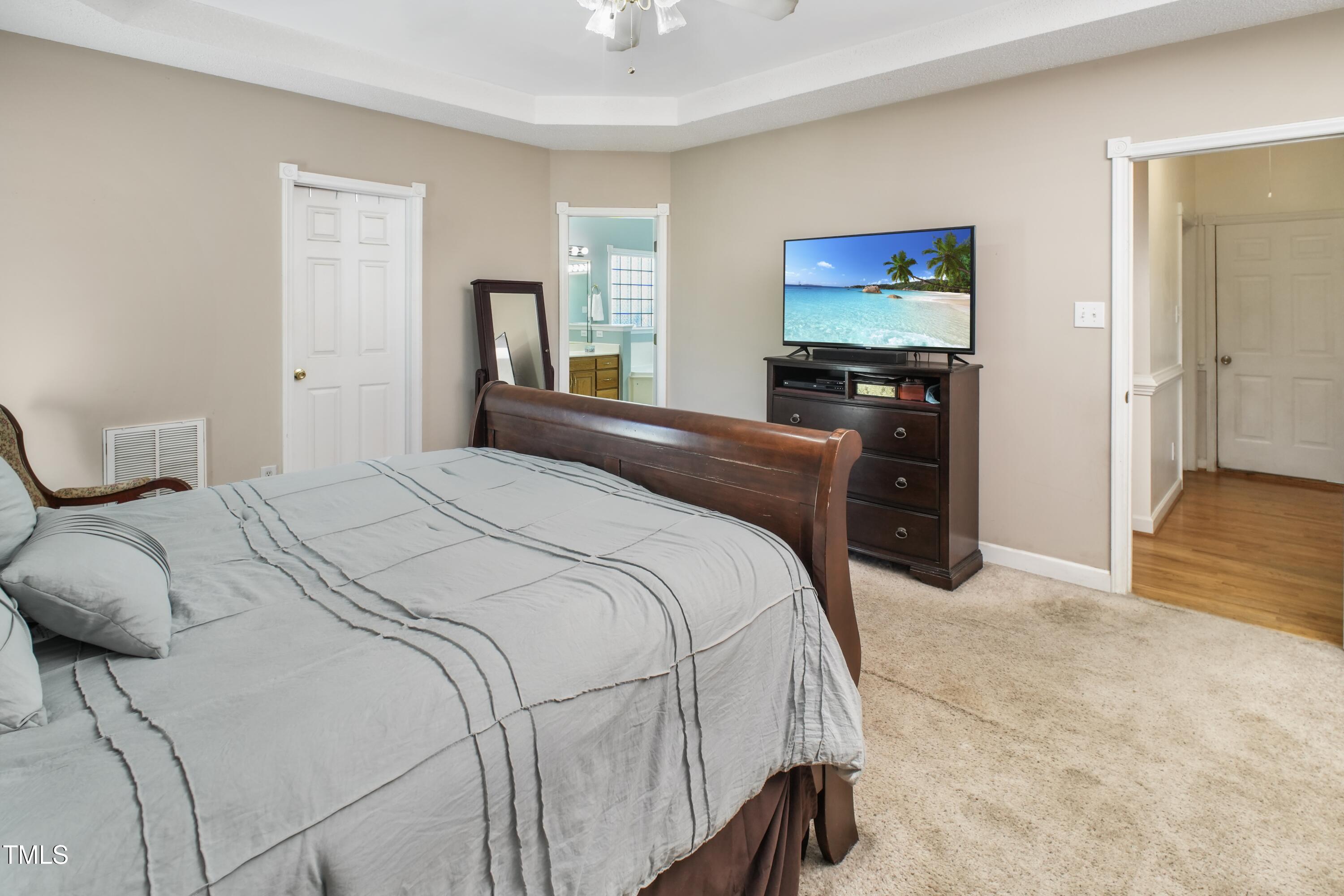 115 Hunters Walk Lane Clinton, NC 28328 - Photo 25 of 39 a bedroom with a bed and a flat screen tv