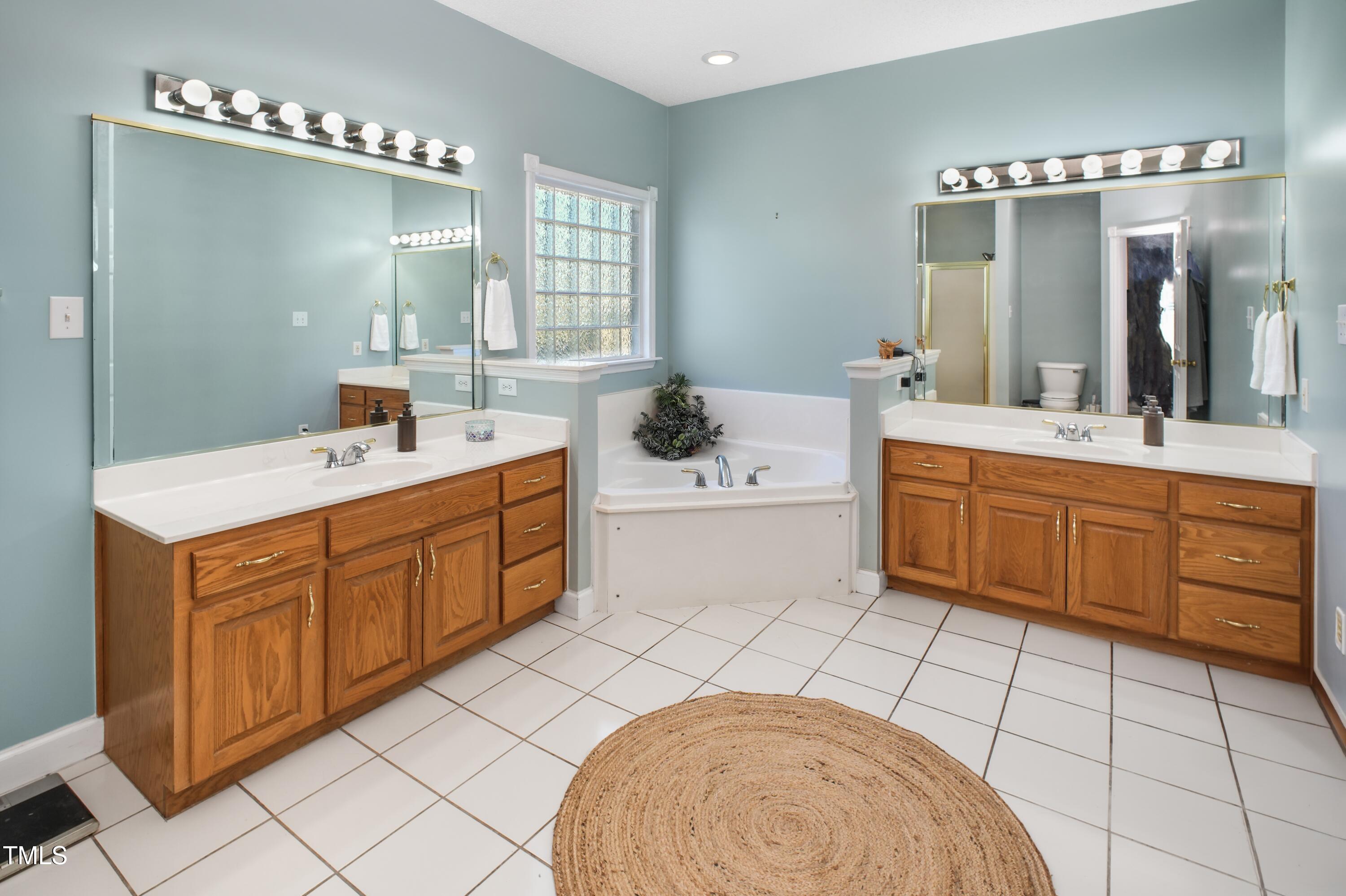 115 Hunters Walk Lane Clinton, NC 28328 - Photo 26 of 39 a spacious bathroom with a double vanity sink mirror and bathtub