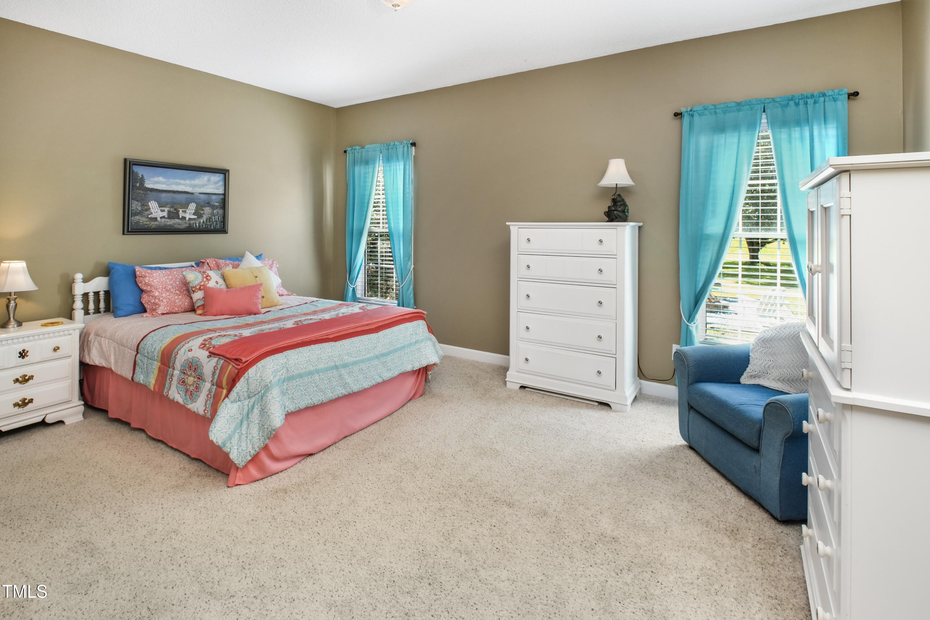 115 Hunters Walk Lane Clinton, NC 28328 - Photo 29 of 39 a bedroom with a bed and a couch