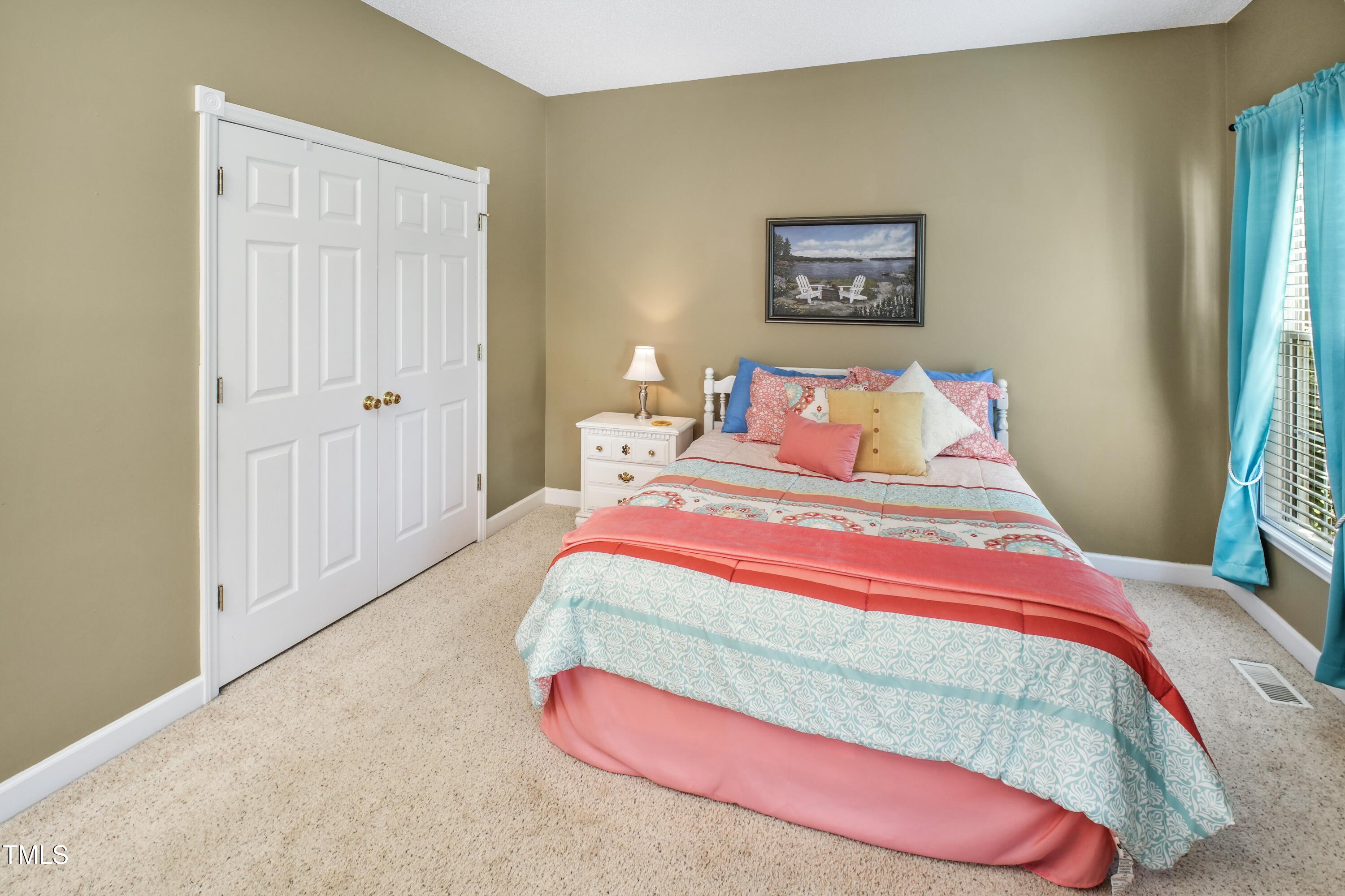 115 Hunters Walk Lane Clinton, NC 28328 - Photo 30 of 39 a bedroom with a bed and a painting on the wall