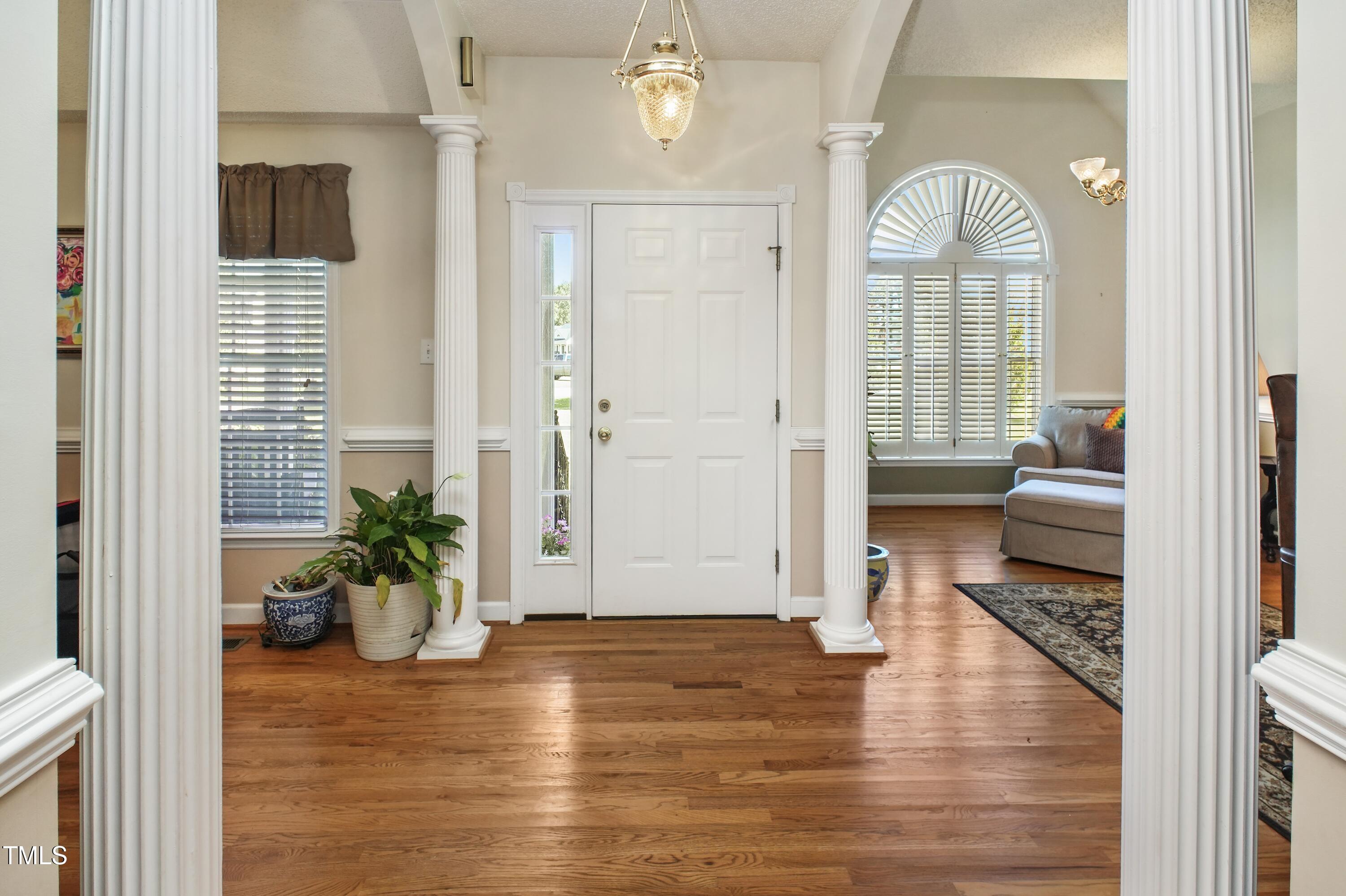 115 Hunters Walk Lane Clinton, NC 28328 - Photo 5 of 39 a view of a hallway with wooden floor and a living room