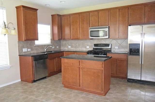 11112 Old Quarry Road Austin, TX 78717 - Photo 3 of 14 a kitchen with stainless steel appliances granite countertop a refrigerator a stove a sink and a microwave