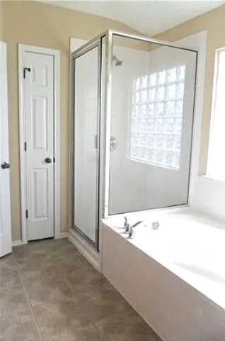 a bathroom with a bathtub and a shower