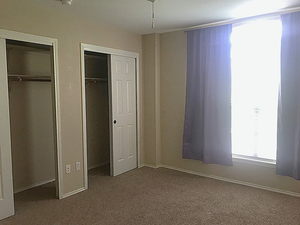 11112 Old Quarry Road Austin, TX 78717 - Photo 8 of 14 an empty room with windows and closet