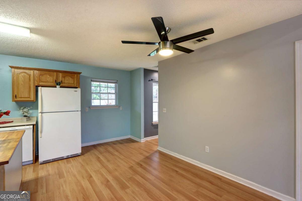 221 Oakwood Court Rincon, GA 31326 - Photo 15 of 35 a view of empty room with wooden floor and fan