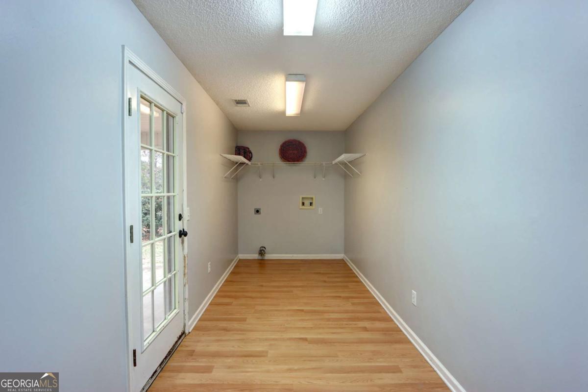 221 Oakwood Court Rincon, GA 31326 - Photo 17 of 35 a view of a hallway view with wooden floor and staircase