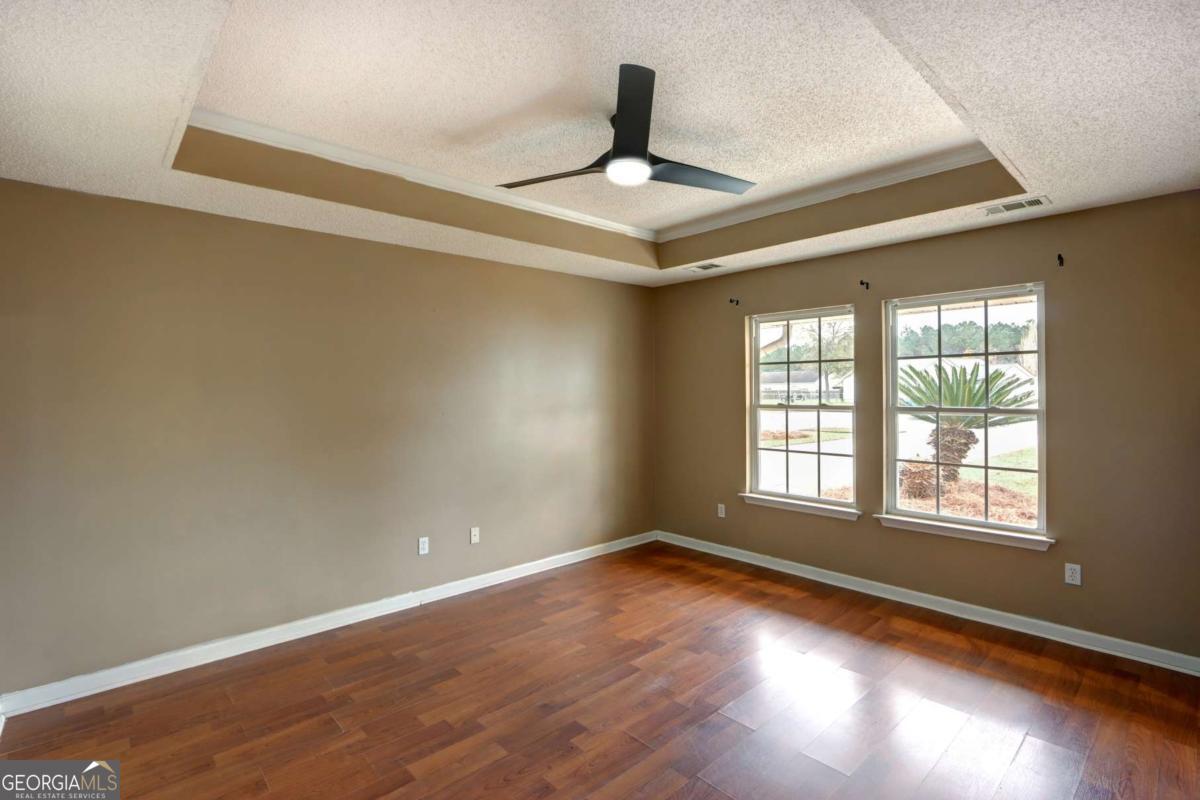 221 Oakwood Court Rincon, GA 31326 - Photo 19 of 35 a view of an empty room with wooden floor and a window