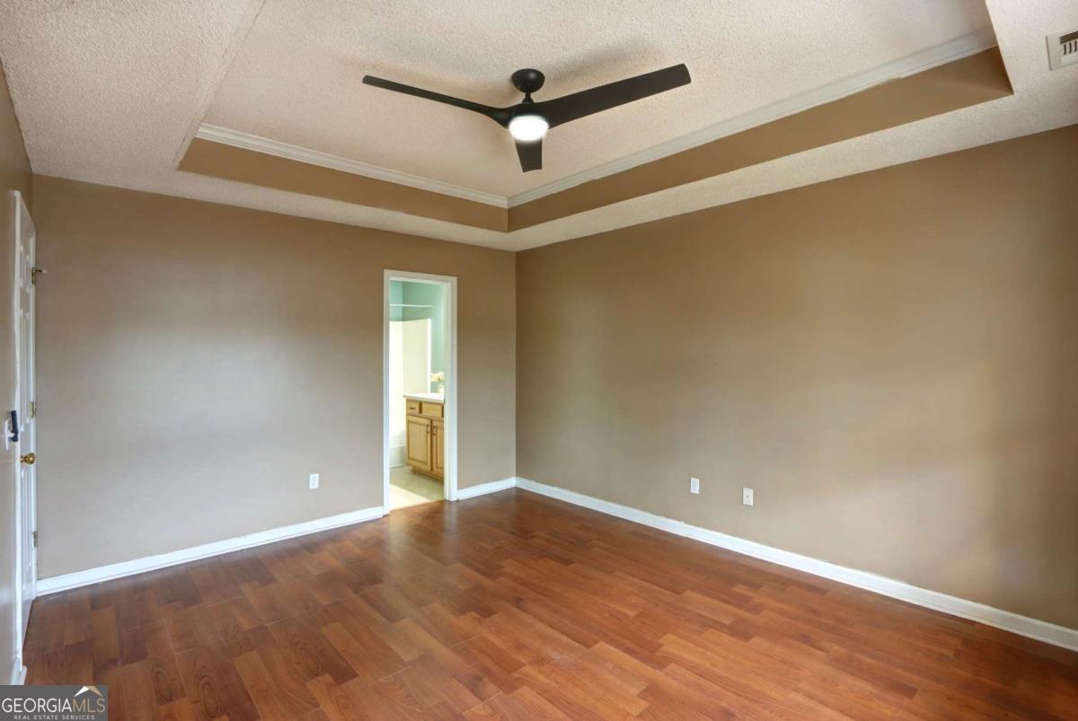 221 Oakwood Court Rincon, GA 31326 - Photo 20 of 35 a view of empty room with wooden floor and fan