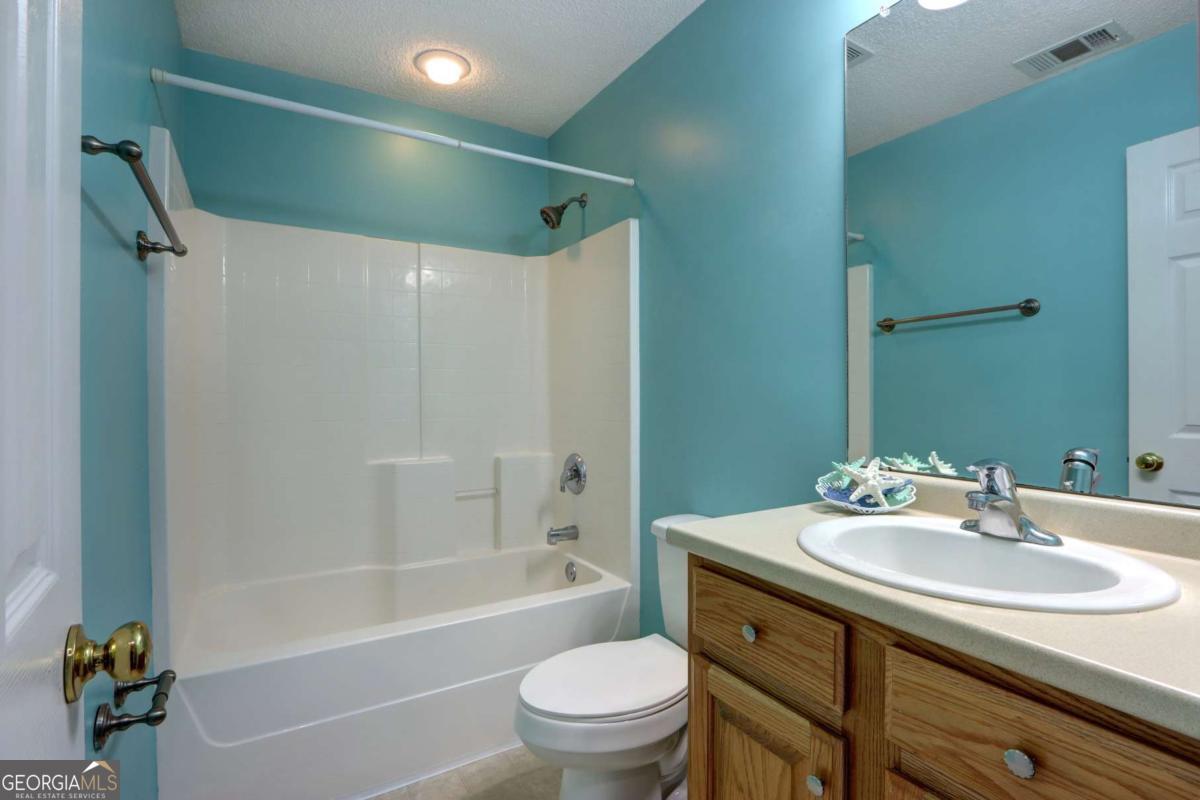 221 Oakwood Court Rincon, GA 31326 - Photo 26 of 35 a bathroom with a sink toilet and a bathtub