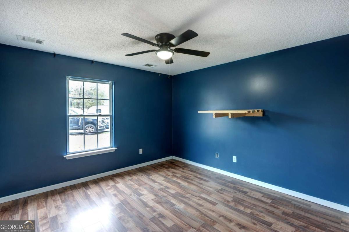 221 Oakwood Court Rincon, GA 31326 - Photo 29 of 35 an empty room with windows and fan