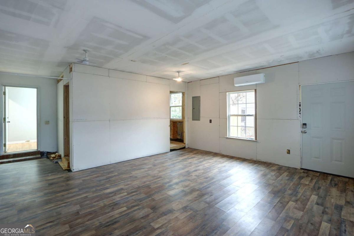 221 Oakwood Court Rincon, GA 31326 - Photo 30 of 35 an empty room with wooden floor and windows