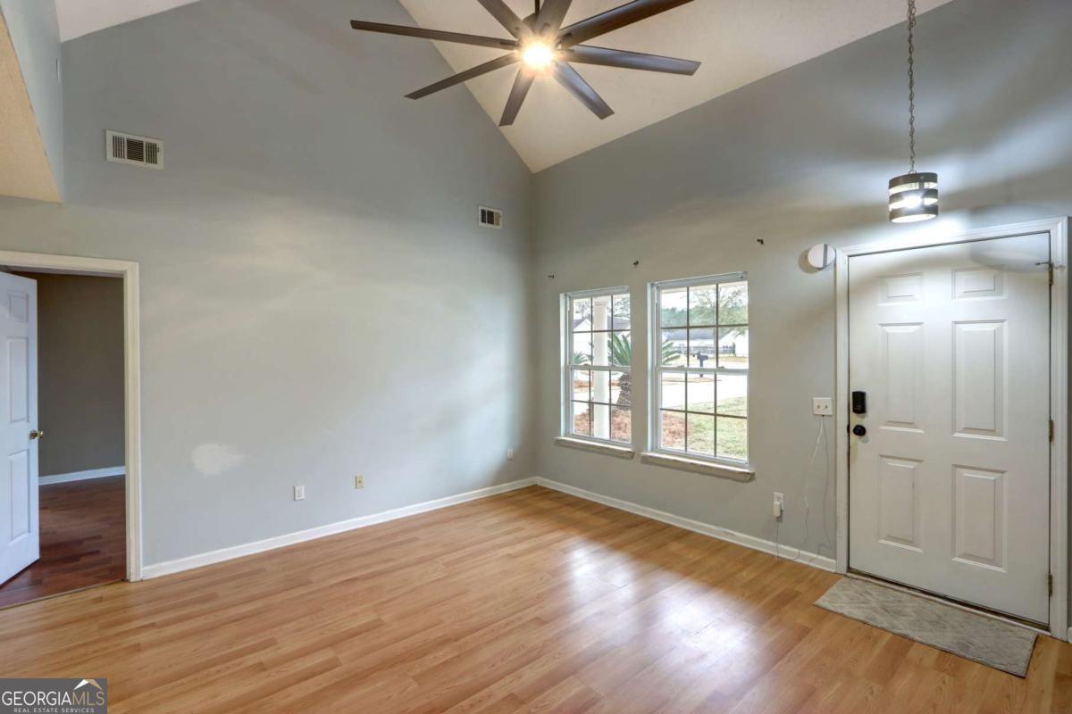 221 Oakwood Court Rincon, GA 31326 - Photo 6 of 35 an empty room with wooden floor and windows