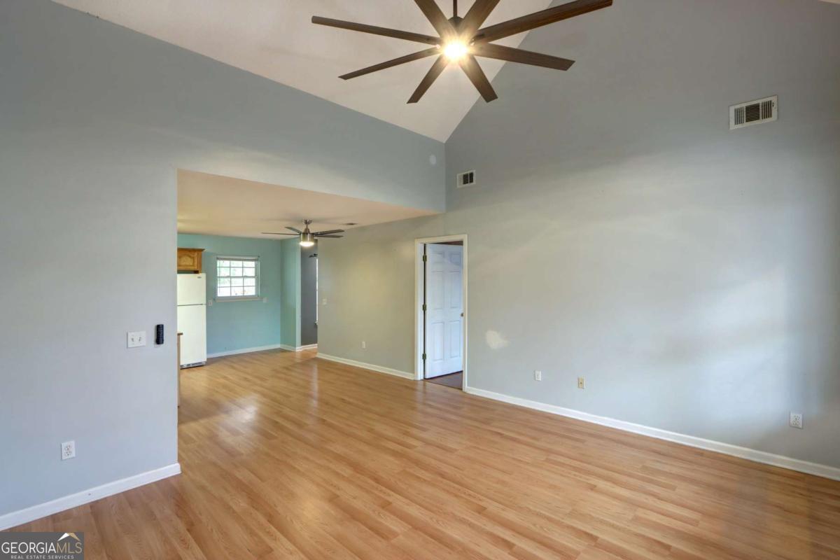 221 Oakwood Court Rincon, GA 31326 - Photo 8 of 35 an empty room with wooden floor and windows