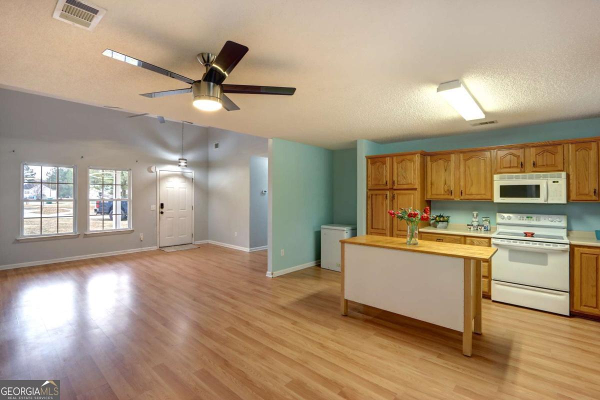 221 Oakwood Court Rincon, GA 31326 - Photo 9 of 35 a kitchen with stainless steel appliances a stove top oven a sink and a window