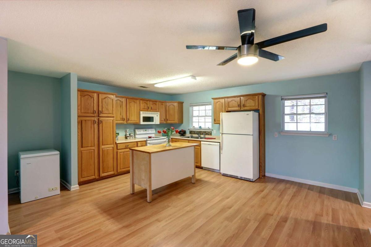 221 Oakwood Court Rincon, GA 31326 - Photo 10 of 35 a kitchen with a refrigerator and white cabinets