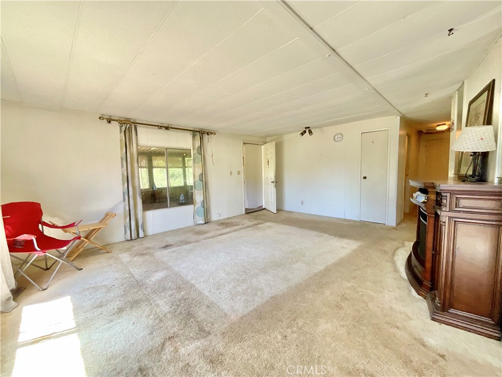 7282 Marin Street Nice, CA 95464 - Photo 49 of 69 a spacious bedroom with a bed and wooden floor