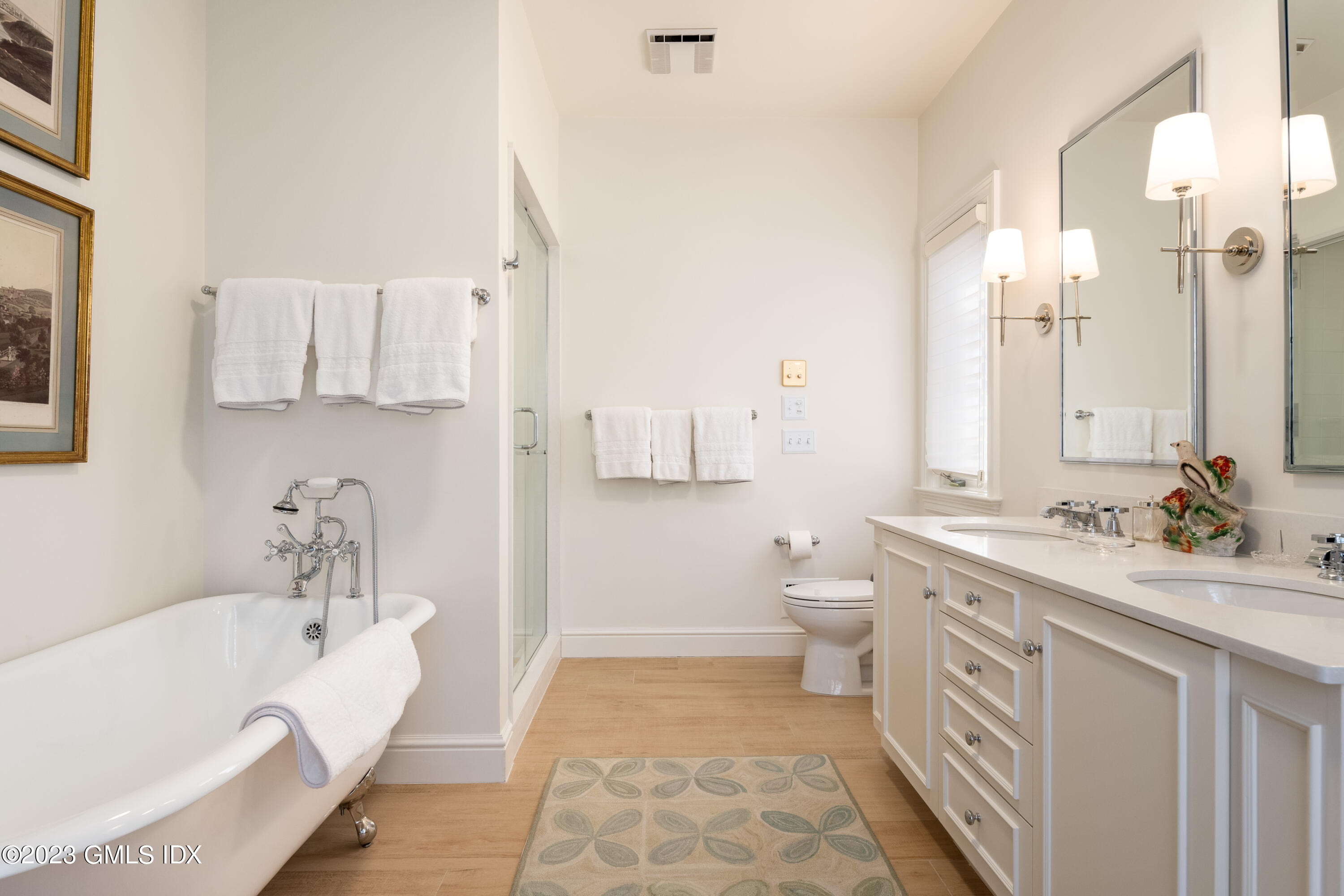 470 June Road Stamford, CT 06903 - Photo 12 of 26 a bathroom with a double vanity sink a toilet and a bathtub