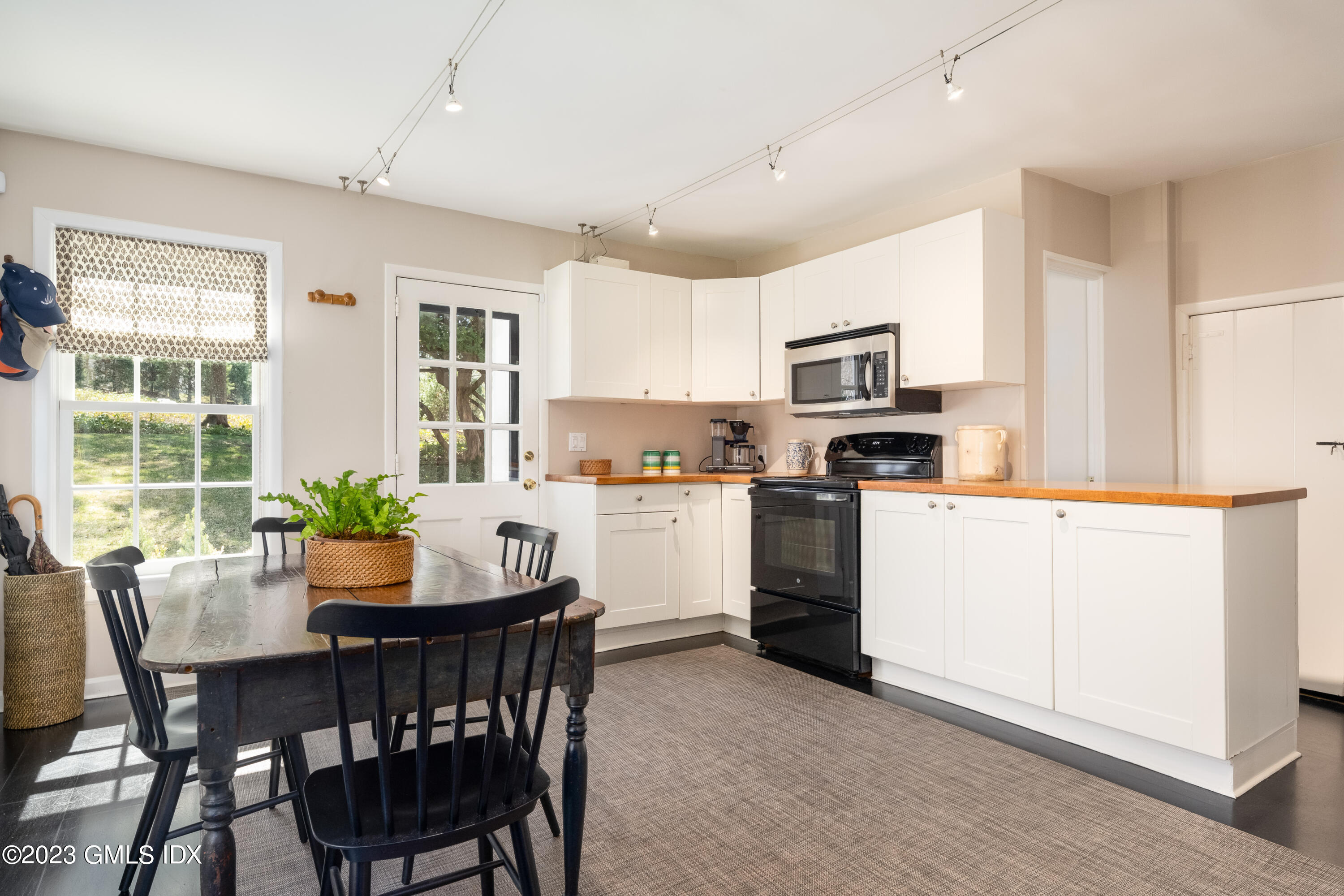 470 June Road Stamford, CT 06903 - Photo 22 of 26 a kitchen with a dining table chairs and refrigerator