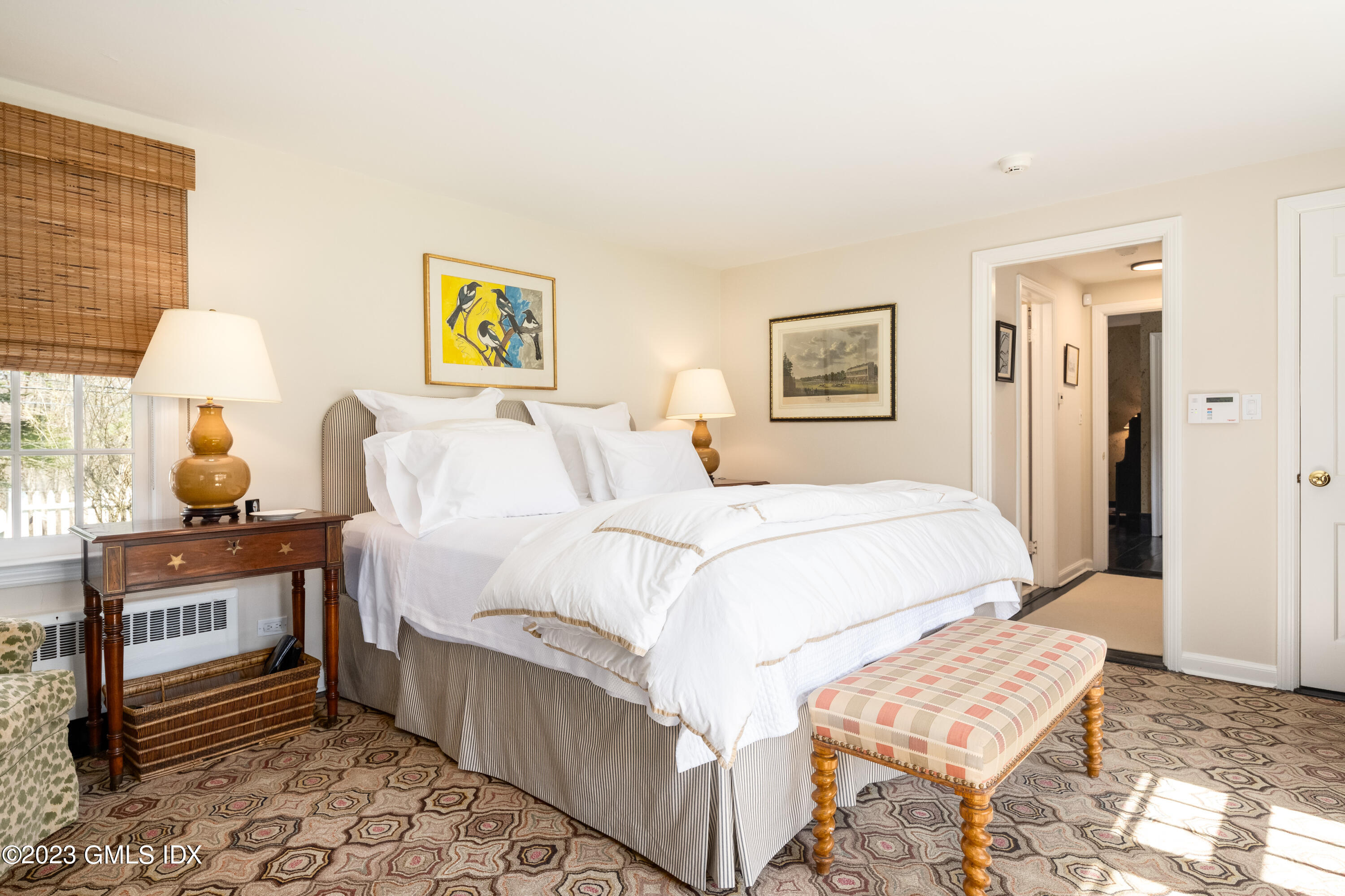 470 June Road Stamford, CT 06903 - Photo 23 of 26 a bedroom with a bed and a lamp on table