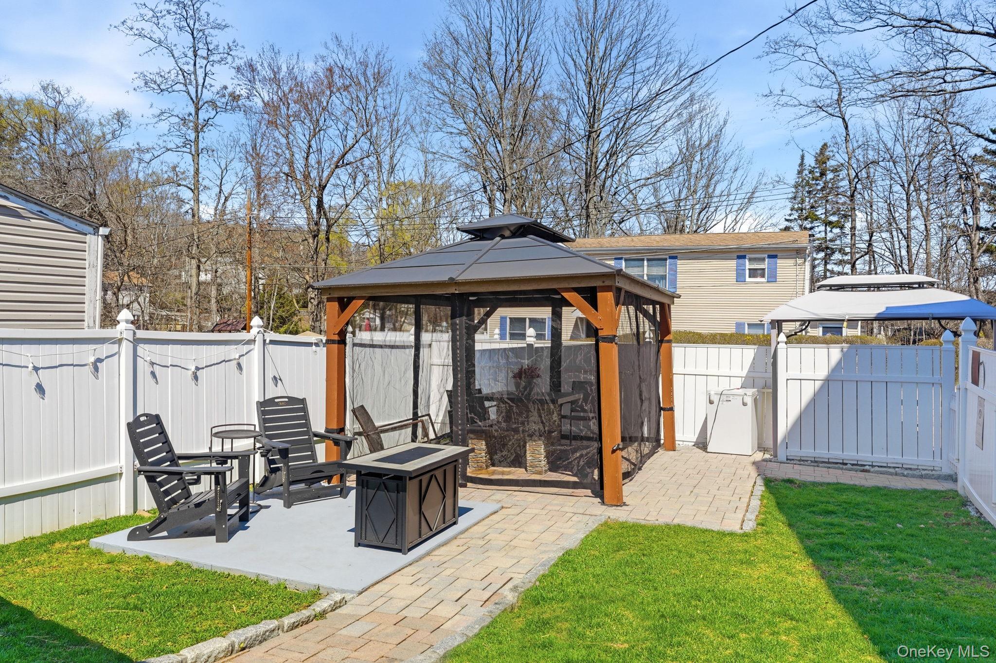 142 Orchard Road Mahopac, NY 10541 - Photo 5 of 29 Enjoy the outside with a covered patio, Fire pit, and fenced-in yard for privacy.