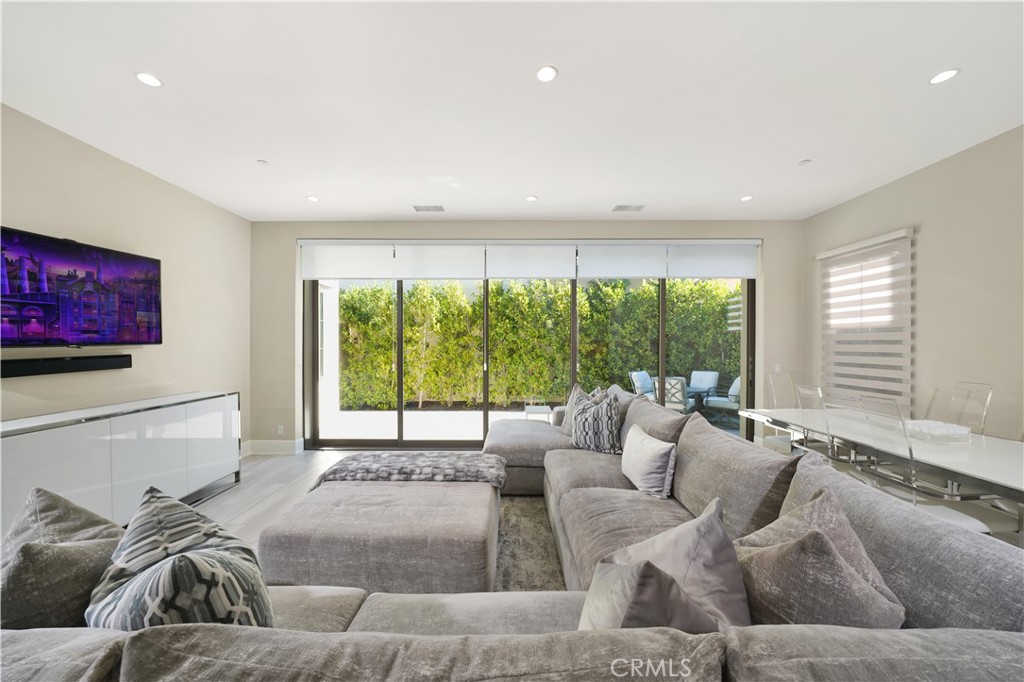 a living room with furniture and large windows