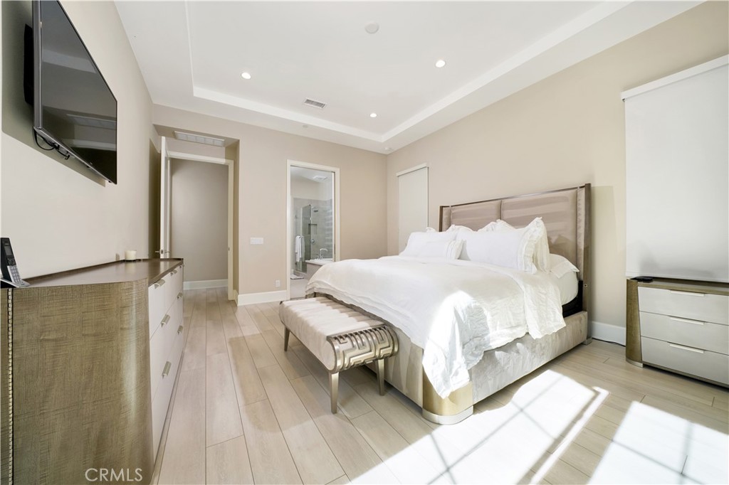 208 Villa Ridge Irvine, CA 92602 - Photo 17 of 46 a bedroom with a bed a flat screen tv and painting on the wall